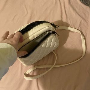 Women’s cream purse. No rips or tears, all zippers work. Has three pockets.